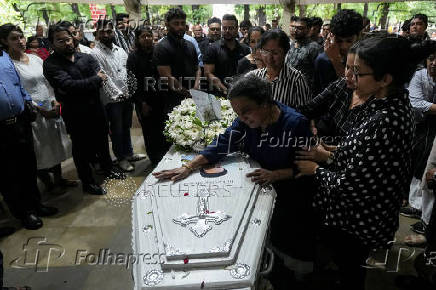 Friends and family members mourn near the coffin of Co-Pilot Clive Kunder, who died after an AIR India Boeing 787-8 Dreamliner plane crashed during take-off from an airport, in Mumbai