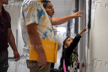 A migrant is detained by federal immigration officers at U.S. immigration court