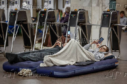People take shelter inside a metro station during an air raid alert in Kyiv