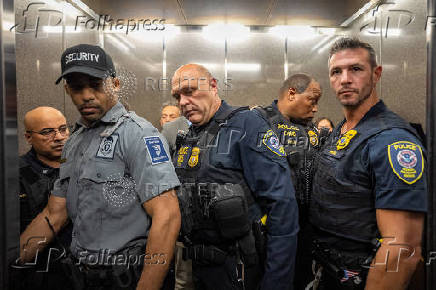 DHS and GSA officers depart in an elevator after detaining local politicians and New York City Comptroller Brad Lander for conducting a sit in demonstration after being denied access to inspect detention cells at U.S. immigration court in New York City