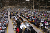Bangladeshi garment workers sew at a textile factory in Gazipur