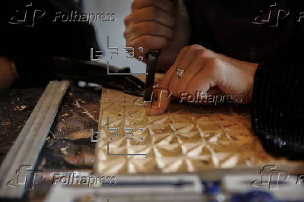 Afghan girl teach Nuristani wood carving skills at a workshop in Kabul