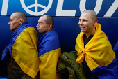 Ukrainian prisoners of war react as they return after a swap in an undisclosed location in Ukraine