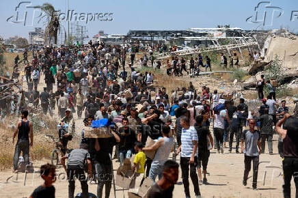 Palestinians carry aid supplies which they received from the U.S.-backed Gaza Humanitarian Foundation