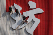Workers paint the facade of People?s Park Complex, a residential building popular with social media content creators, in Chinatown, Singapore