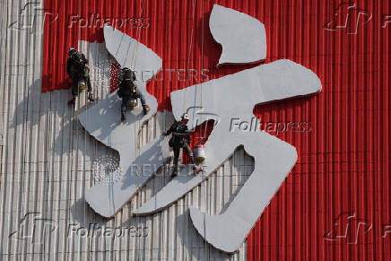 Workers paint the facade of People?s Park Complex, a residential building popular with social media content creators, in Chinatown, Singapore