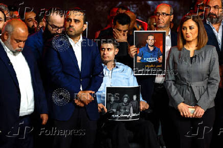 Al Jazeera staff members gather at the network?s studios to remember their colleagues killed in Gaza City by an Israeli strike, in Doha