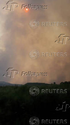 Thick smoke fills the air in northwest Spain as wildfire rages