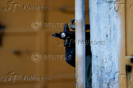 Israeli troops stand guard during a weekly settlers' tour in Hebron