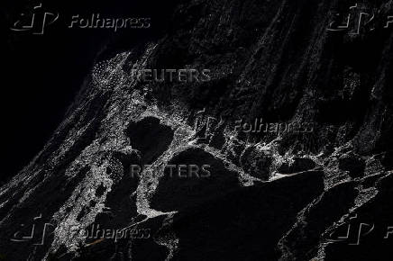 Debris and dust from a crumbling glacier that partially collapsed and tumbled onto the village of Blatten