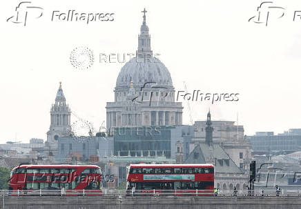 FILE PHOTO: London buses cross Waterloo Bridge with St. Paul's Cathedral seen behind