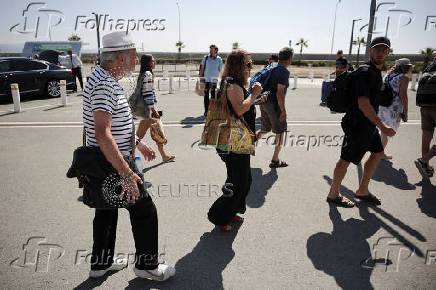 People board Crown Iris, a cruise ship which will be used to assist in the departure of Israelis from Cyprus, at the port in Limassol