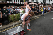 Competitors participate in the Pinner Wheelbarrow Race as part of a St. George's Day celebration, in London