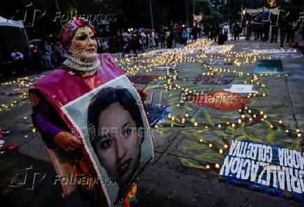 Family members and friends of missing persons participate in a candlelight vigil, in Mexico City