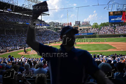 A man sells beer as the Chicago Cubs and the Milwaukee Brewers play at Wrigley Field in Chicago, USA