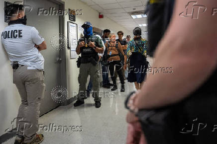 A migrant is detained by federal immigration officers at U.S. immigration court