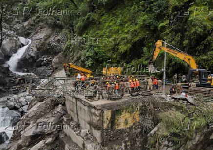 A drone view of BRO and SDRF officials attempting to build a makeshift bridge in Gangnani
