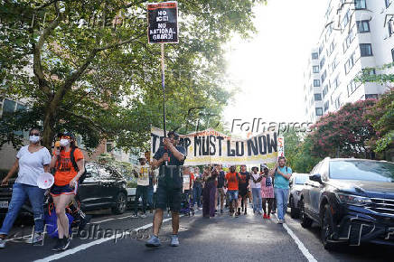 People protest after U.S. President Trump announced he would deploy the National Guard to the nation's capital and place D.C.'s Metropolitan Police Department under federal control, in Washington