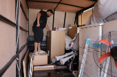 Syrian returnee Ahmed Al-hadid, loads his belongings onto a truck, in Aleppo's countryside