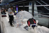People shelter at Tel Aviv Light Rail Station amid ongoing Iranian ballistic missile threat