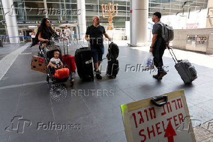 Israeli nationals arrive at Ben Gurion International airport from abroad, in Tel Aviv