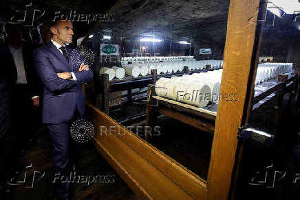 France's President Emmanuel Macron visits the cellar of the Roquefort Societe cheese producer plant