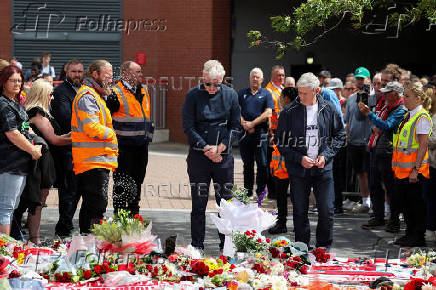Fans pay their respects outside Anfield Stadium, on the day of the funeral of Liverpool soccer player Diogo Jota in Portugal, in Liverpool