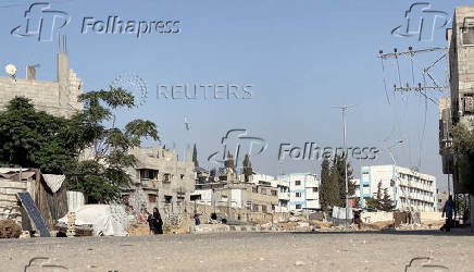 A girl runs from the scene as a missile lands during Israeli strikes on a school sheltering displaced people at the Bureij refugee camp in the central Gaza Strip