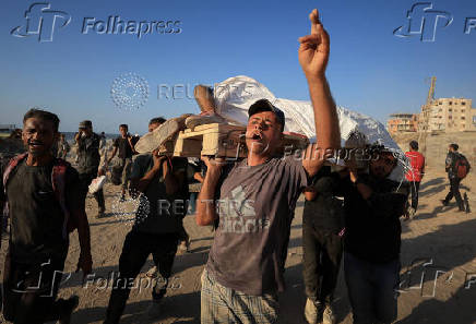 Palestinians carry aid supplies that entered Gaza through Israel, in Beit Lahia