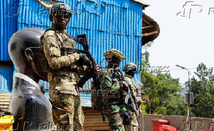 FILE PHOTO: Members of the M23 rebel group stand guard