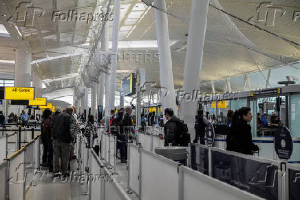 Travellers make their way to a security checkpoint at John F. Kennedy International Airport (JFK) in New York City