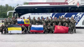 Russian soldiers pose for cameras in Belarus after release from Ukraine on second day of POW exchange
