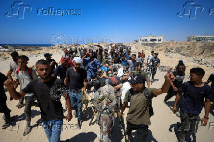 Palestinian casualties of Israeli fire, who were seeking aid supplies, are transported in the northern Gaza Strip