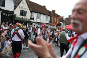 Members of the Merrydowners Morris dancing troupe perform at a St. George's Day celebration, in London