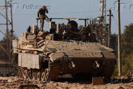 A truck transports a tank along the Israel-Gaza border