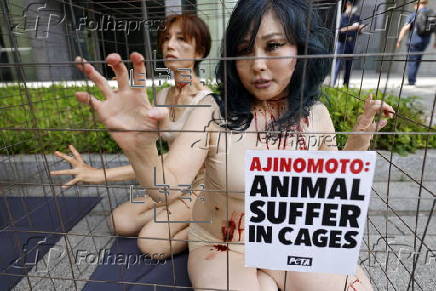PETA supporters stage a protest during Ajinomoto annual shareholders' meeting