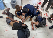 Palestinians wounded by Israeli fire near an aid center, according to medics, receive treatment in Khan Younis