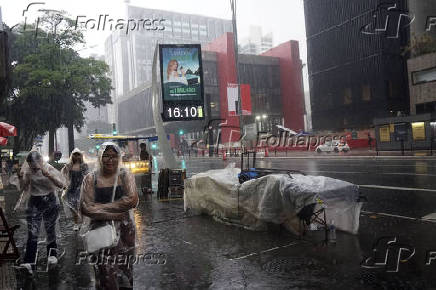 Pedestres enfrentam chuva e queda de temperatura em SP