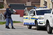 Police officers inspect the scene where kidnapped U.S. pastor, Josh Sullivan, was rescued last night in a shootout during which three suspects were killed, in KwaMagxaki