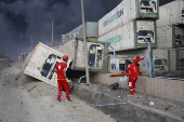 Iranian Red Crescent rescuers work following an explosion at the Shahid Rajaee port in Bandar Abbas