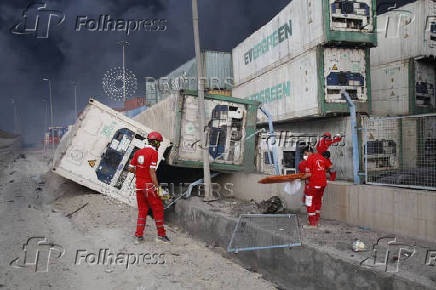 Iranian Red Crescent rescuers work following an explosion at the Shahid Rajaee port in Bandar Abbas