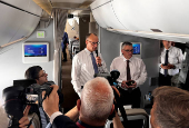 Newly elected German Chancellor Friedrich Merz talks to journalists on a plane en route to France
