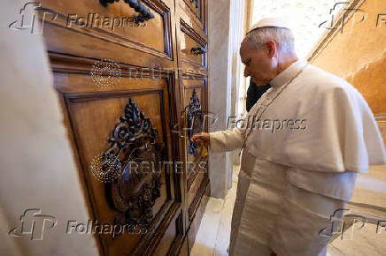 Pope Leo XIV unlocks the door to the Apostolic Palace after it was unsealed, at the Vatican