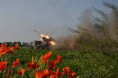Ukrainian servicemen fire a multiple rocket launcher towards Russian troops on a front line in Zaporizhzhia region