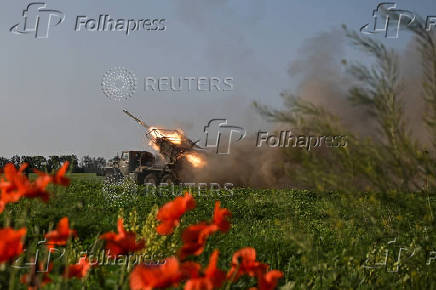 Ukrainian servicemen fire a multiple rocket launcher towards Russian troops on a front line in Zaporizhzhia region