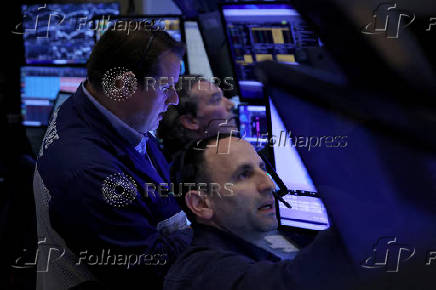 Traders work on the floor of the NYSE in New York
