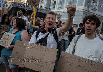 Ukrainians protest against a newly passed law, which curbs independence of anti-corruption institutions in Kyiv
