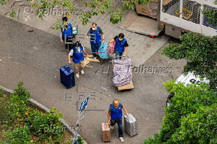 Hong Kong residents affected by the fire gather their belongings from their apartments
