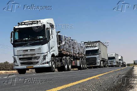 Trucks carrying aid arrive at the Kerem Shalom crossing between Israel and Gaza, on its Israeli side