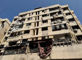 A view shows a damaged building in the aftermath of Israeli strikes, in Beirut's southern suburbs